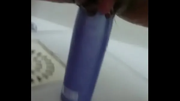 Show Stuffing the shampoo into the pussy and the growing clitoris drive Clips
